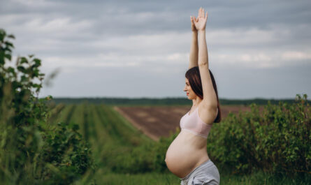 ciezarna kobieta z podniesionymi rekami